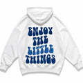 Ice-white oversized hoodie photographed flat from behind, Enjoy The Little Things printed across the back in blue