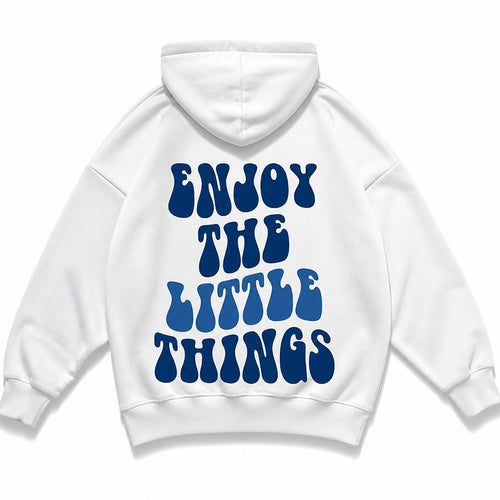 Ice-white oversized hoodie photographed flat from behind, Enjoy The Little Things printed across the back in blue